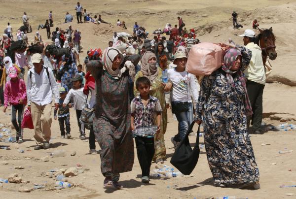 Refugiados sírios em fuga para o Iraque, agosto de 2013